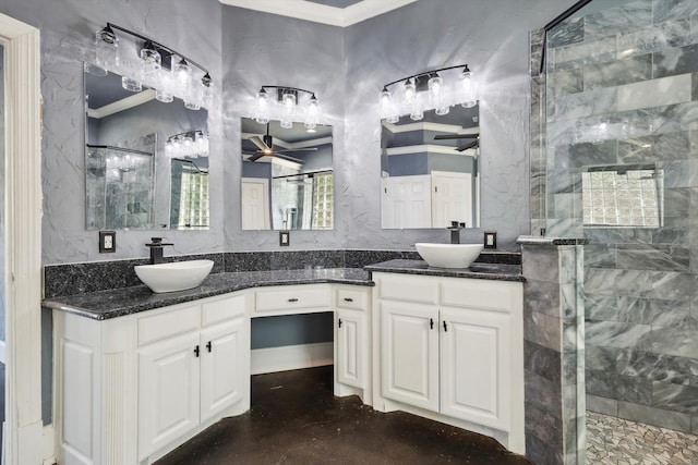 bathroom with vanity, ceiling fan, ornamental molding, and tiled shower