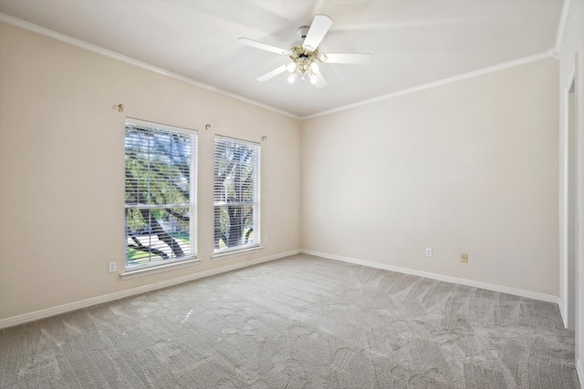 spare room featuring light colored carpet, ceiling fan, and crown molding