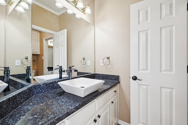 bathroom featuring vanity and ornamental molding