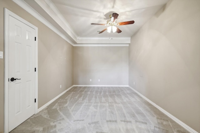 carpeted spare room with ceiling fan and crown molding