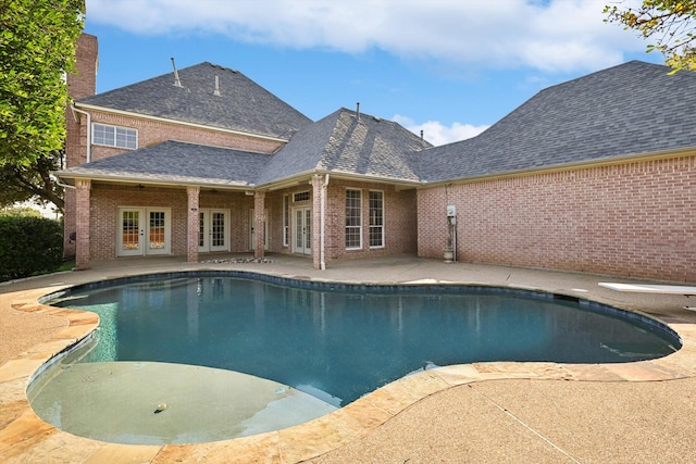 view of swimming pool featuring french doors and a patio