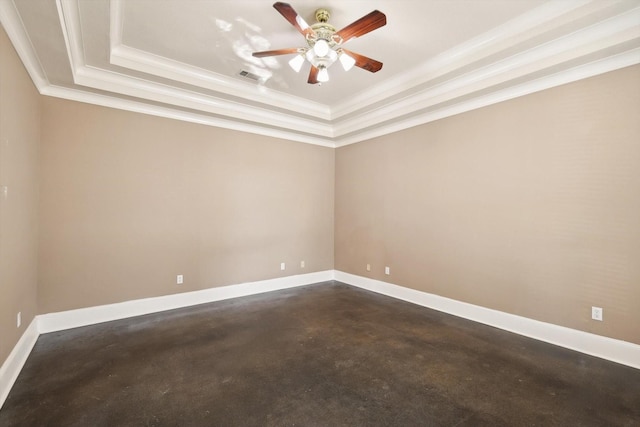 empty room with a raised ceiling and crown molding