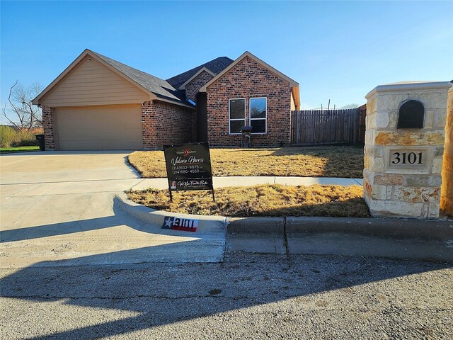 view of front of home with a garage and a front lawn