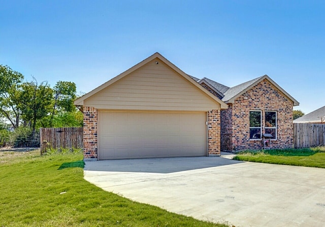 view of front of home with a garage and a front lawn