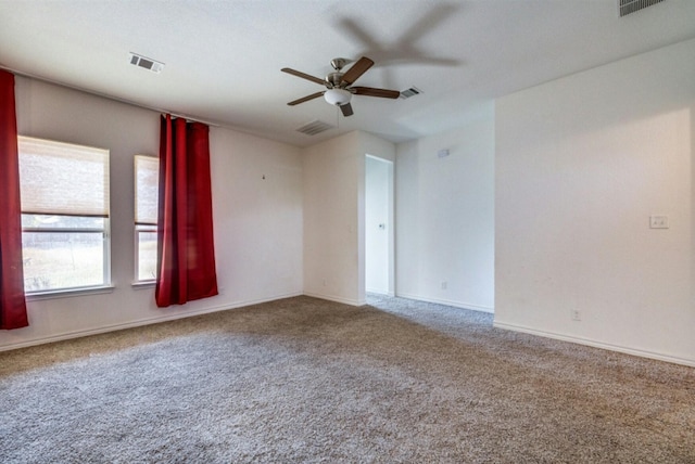 carpeted spare room featuring ceiling fan