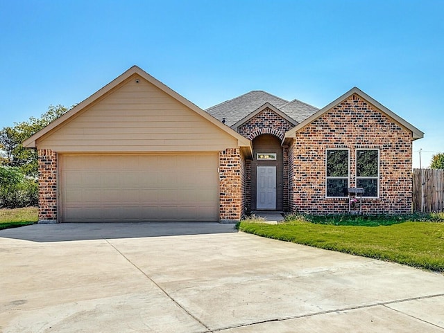 view of front of house featuring a garage and a front lawn