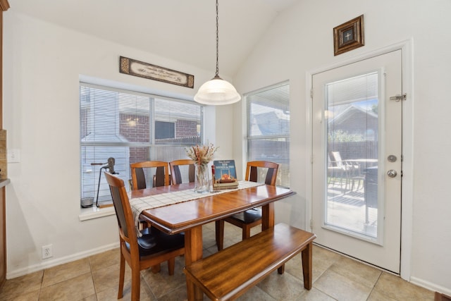 dining space with lofted ceiling and light tile patterned floors