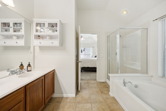 bathroom with vanity, ceiling fan, tile patterned floors, and plus walk in shower