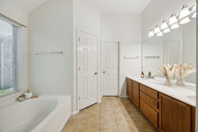 bathroom featuring vanity, a tub, and tile patterned floors