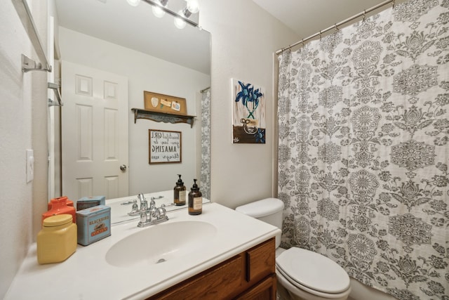 bathroom with vanity, toilet, and walk in shower