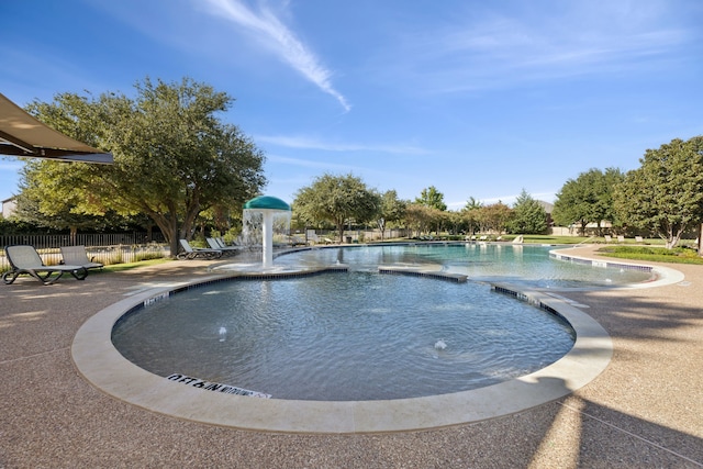 view of swimming pool with pool water feature