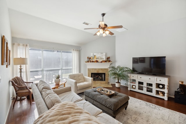 living room with lofted ceiling, dark hardwood / wood-style floors, a fireplace, and ceiling fan