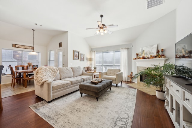 living room featuring vaulted ceiling, dark hardwood / wood-style flooring, and plenty of natural light