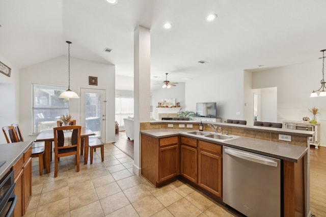 kitchen with sink, vaulted ceiling, dishwasher, and hanging light fixtures