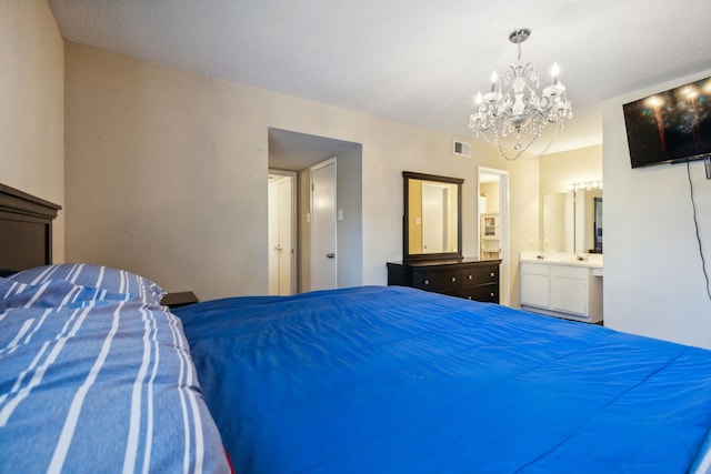 bedroom featuring a notable chandelier and ensuite bath