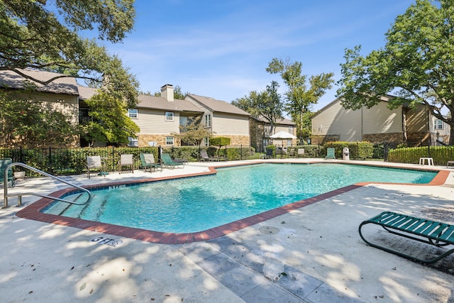 view of swimming pool with a patio area