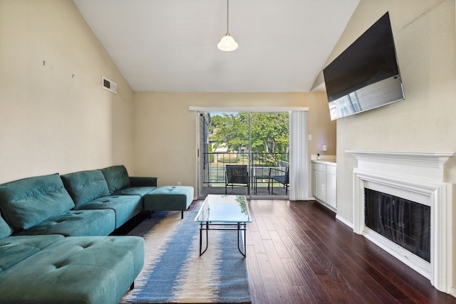 living room with dark wood-type flooring and vaulted ceiling