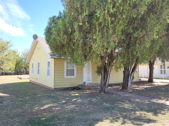 obstructed view of property with a front lawn