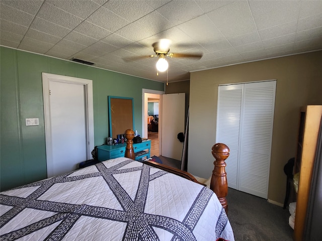 bedroom with dark colored carpet, a closet, and ceiling fan