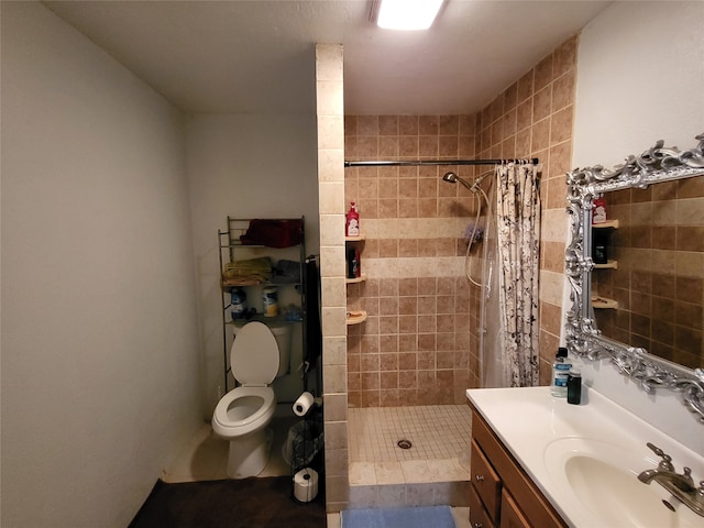 bathroom with tile patterned flooring, a shower with curtain, vanity, and toilet