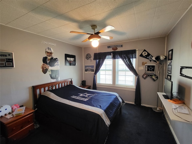 bedroom featuring ceiling fan and dark colored carpet