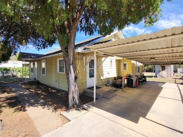 view of front of property featuring a carport