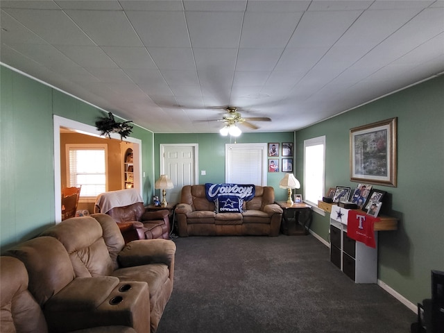 carpeted living room with ceiling fan