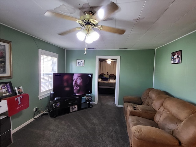 living room featuring ceiling fan and dark colored carpet