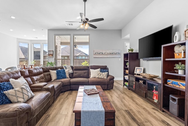 living room with ceiling fan and light hardwood / wood-style flooring