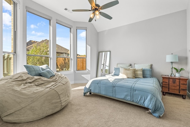 bedroom with vaulted ceiling, carpet flooring, and ceiling fan