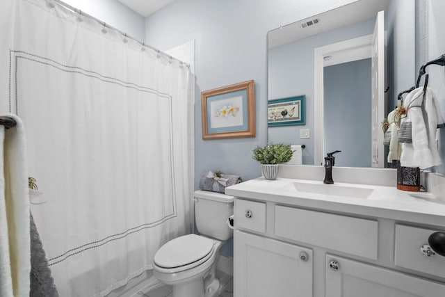 bathroom featuring walk in shower, vanity, and toilet