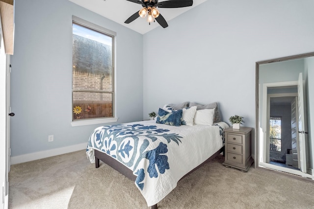 carpeted bedroom featuring multiple windows and ceiling fan