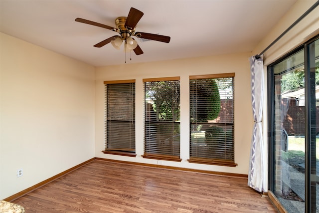 unfurnished room with wood-type flooring and ceiling fan