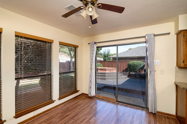 interior space with hardwood / wood-style floors, a textured ceiling, and ceiling fan