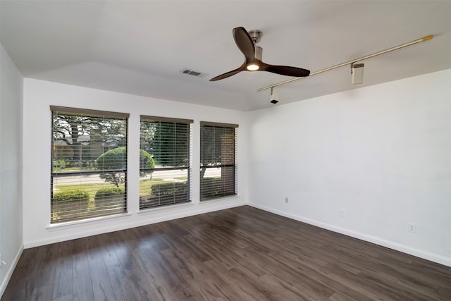 spare room featuring dark hardwood / wood-style floors, track lighting, and ceiling fan