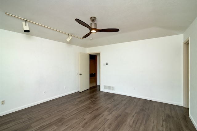 spare room featuring track lighting, dark hardwood / wood-style floors, and ceiling fan