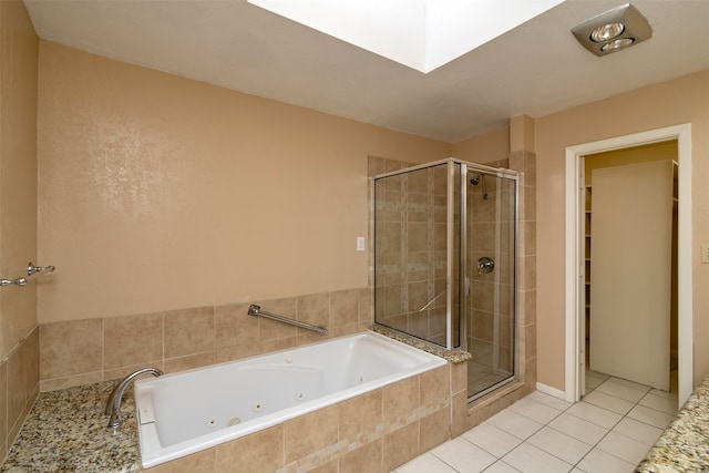 bathroom featuring tile patterned flooring and separate shower and tub