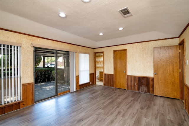 empty room featuring a textured ceiling and hardwood / wood-style flooring