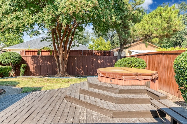 view of yard with a deck and a covered hot tub