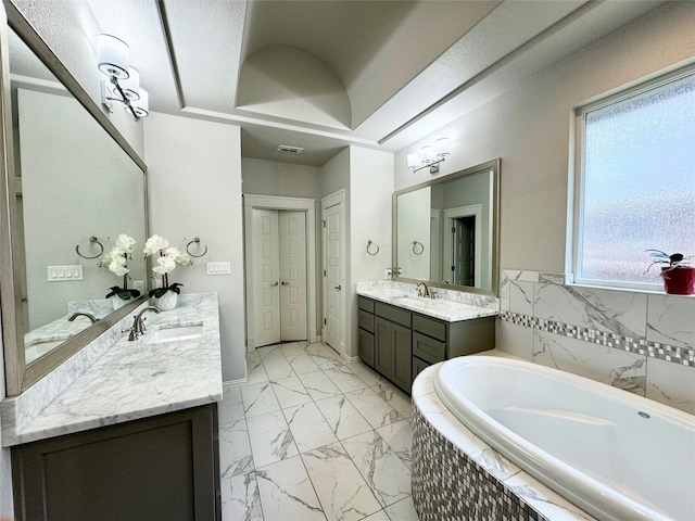 bathroom featuring vanity, tile walls, and tiled tub