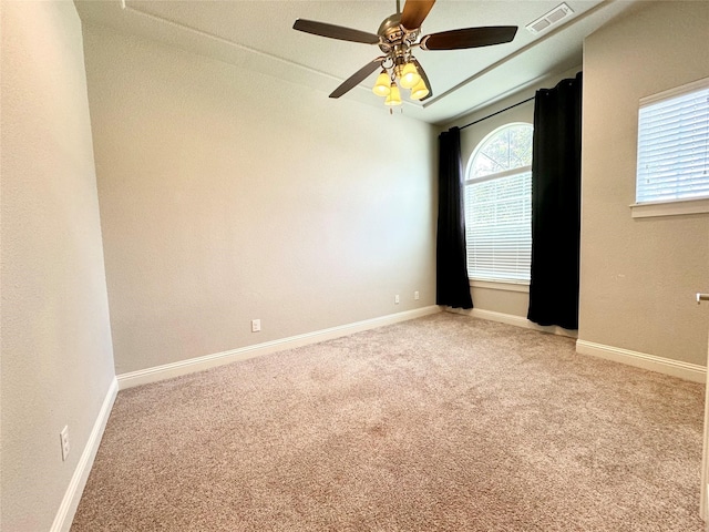 unfurnished room featuring light colored carpet and ceiling fan