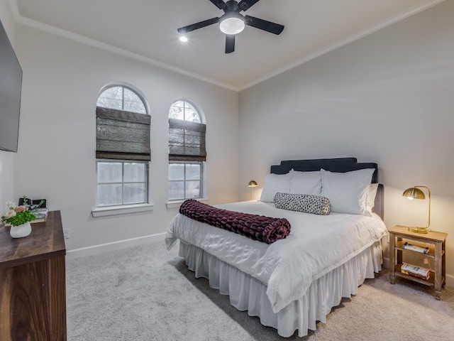 carpeted bedroom featuring crown molding, vaulted ceiling, and ceiling fan