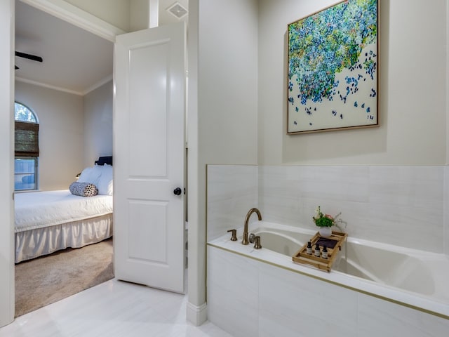 bathroom with tiled bath and ornamental molding