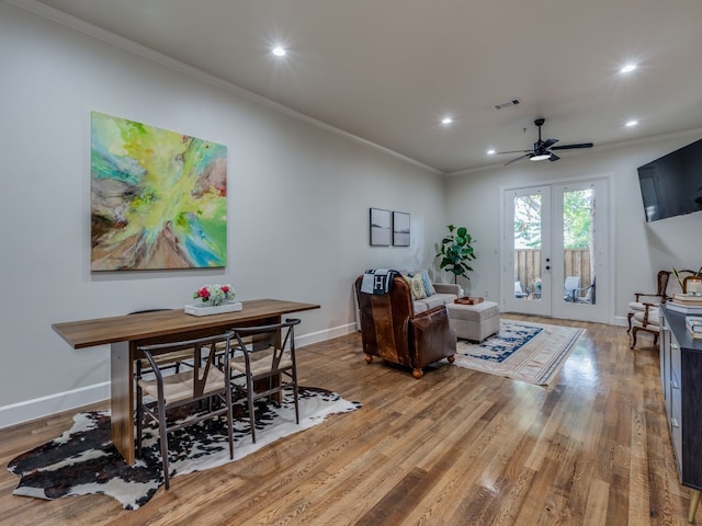 interior space with french doors, hardwood / wood-style flooring, ceiling fan, and crown molding