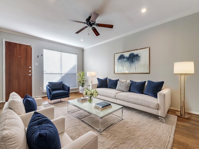 living room featuring wood-type flooring, ceiling fan, and ornamental molding