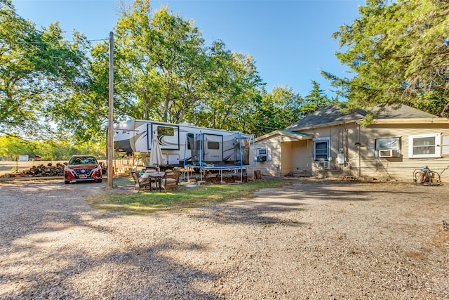 view of front of home featuring cooling unit and a trampoline