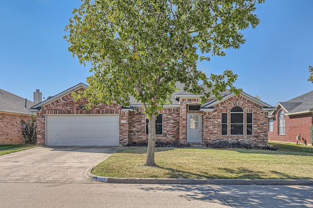 view of front of house with a garage and a front lawn