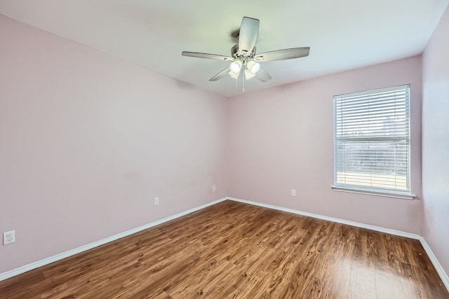 spare room with wood-type flooring and ceiling fan