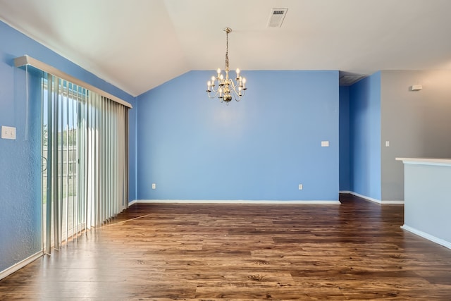 spare room with a chandelier, vaulted ceiling, and dark hardwood / wood-style flooring