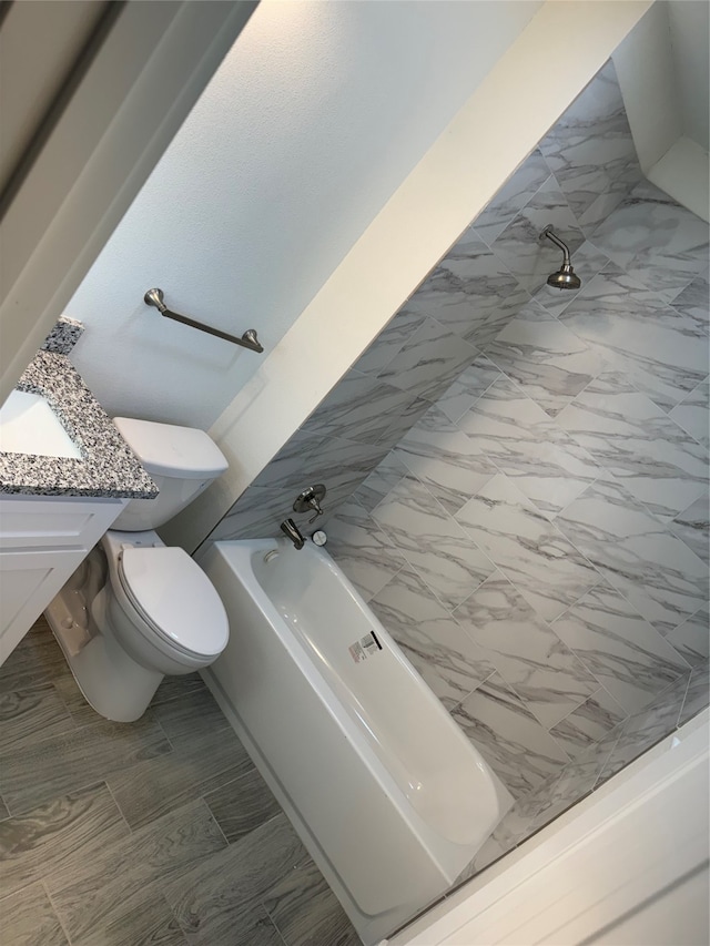 bathroom featuring vanity, a tub, and toilet